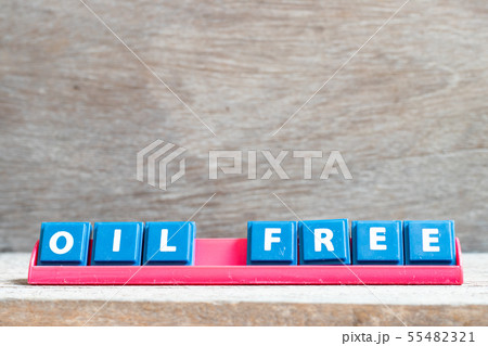 Tile letter on red rack in word oil free 55482321