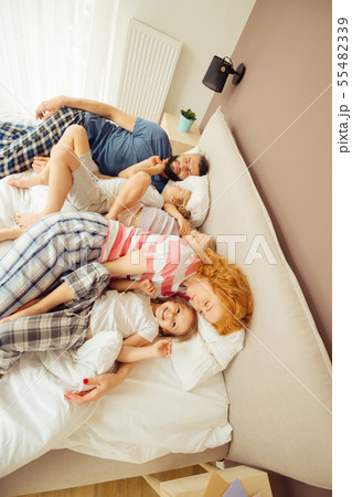 Top view of a happy family in bed 55482339