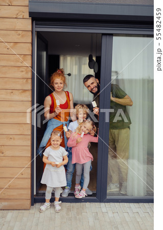 Cheerful nice family standing at the doorstep 55482459