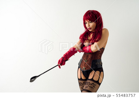 Dominant woman in a red wig corset and leather 55483757