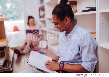 Positive delighted young man enjoying his hobby Positive delighted young man enjoying his hobby 55484679