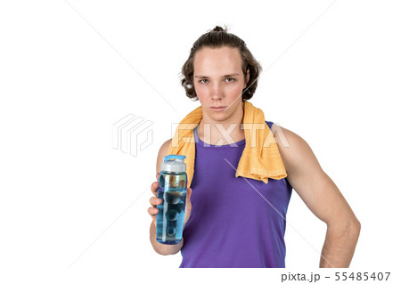 Handsome young man in sport shirt holding bottle 55485407
