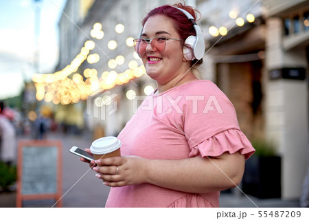 Young and fat woman with smartphone in city Young and fat woman with smartphone in city 55487209