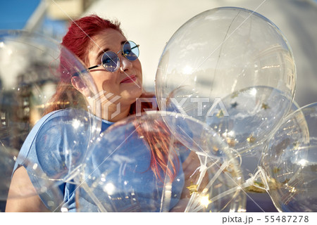 Fat and young woman with air balloons in hand Fat and young woman with air balloons in hand 55487278