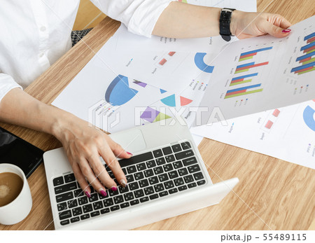 Business team work analyzing charts and graphs Business team work analyzing charts and graphs 55489115