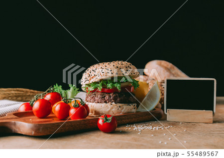 Hamburger homemade on wood table. 55489567