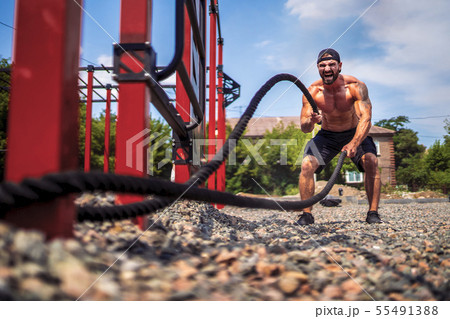 Men work hard with rope, functional training Men work hard with rope, functional training 55491388