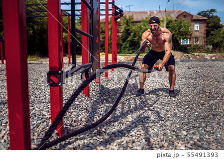 Men work hard with rope, functional training Men work hard with rope, functional training 55491393