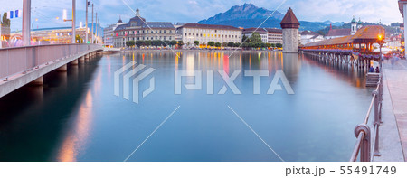 Lucerne. Panorama. The famous Chapel, Kapellbrucke bridge at dawn in night lighting. Lucerne. Panorama. The famous Chapel, Kapellbrucke bridge at dawn in night lighting. 55491749