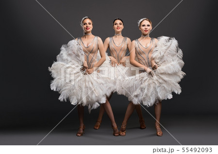 Smiling female dancers with fans during show 55492093