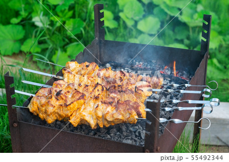 Shish kebab in process of cooking on open fire Shish kebab in process of cooking on open fire 55492344