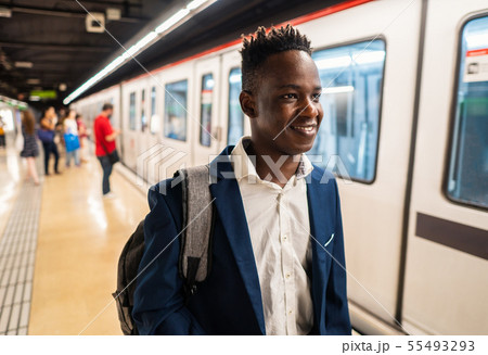 African American businessman wearing blue suit and backpack African American businessman wearing blue suit and backpack 55493293
