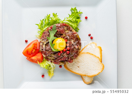 French cuisine, beef steak tartare with raw quail egg yolk French cuisine, beef steak tartare with raw quail egg yolk 55495032