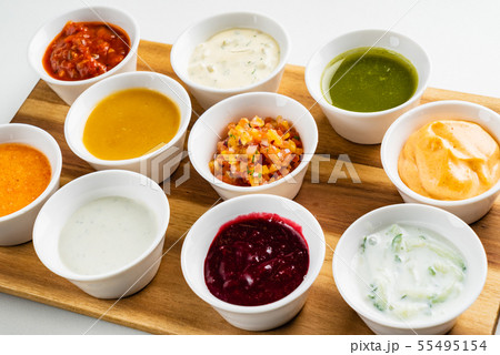 Bowls with sauces on wooden tray Bowls with sauces on wooden tray 55495154