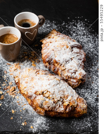 Croissants with almonds on the black background Croissants with almonds on the black background 55495229