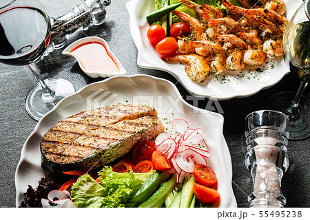 grilled shrimps and salmon steak with fresh vegetables and wine grilled shrimps and salmon steak with fresh vegetables and wine 55495238