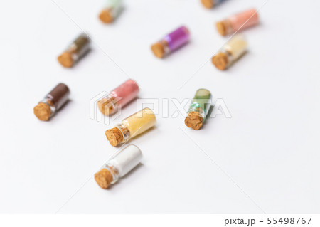 Cosmetics, makeup and beauty concept - Colourful eye shadow in small glass boxes on white background 55498767
