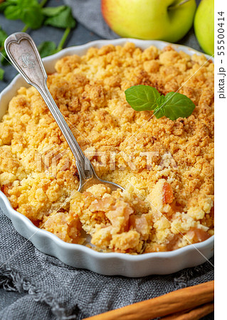 Apple crumble and a dessert spoon closeup. Apple crumble and a dessert spoon closeup. 55500414
