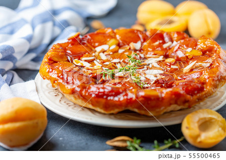 Apricot and almond tarte tatin on a white plate. Apricot and almond tarte tatin on a white plate. 55500465