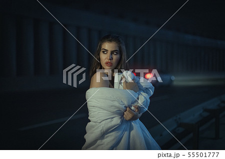 Beautiful woman wrapped herself in a white blanket Beautiful woman wrapped herself in a white blanket 55501777