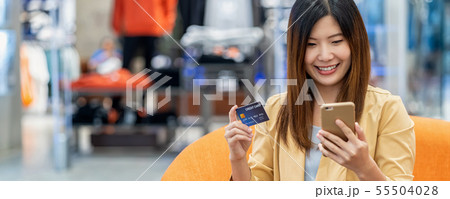 banner of Asian woman using credit card with mobile phone for online shopping in department store over the clothes shop store, technology money wallet and online payment concept, credit card mockup banner of Asian woman using credit card with mobile phone for online shopping in department store over the clothes shop store, technology money wallet and online payment concept, credit card mockup 55504028