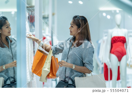 Asian woman looking and choosing the underwear in store shop with happy action at department center Asian woman looking and choosing the underwear in store shop with happy action at department center 55504071
