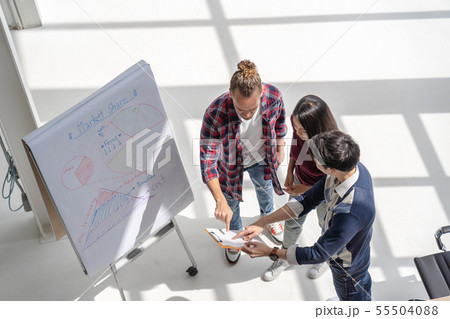 Top view scene of Asian and Multiethnic Business people with casual suit working with brainstorming and pointing to the design concept in the modern workplace, people business group concept 55504088