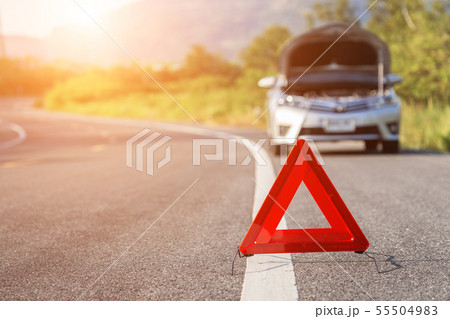 Red emergency stop sign and broken car on the road 55504983