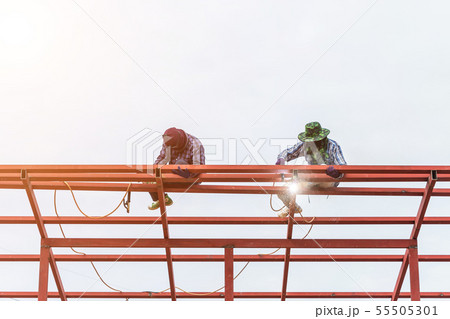 Construction worker welding steel for roof structure Construction worker welding steel for roof structure 55505301