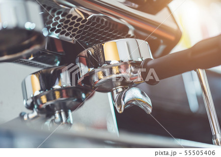 Hand of barista holding coffee tamper and making coffee preparation 55505406