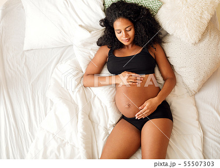 Shot from above of a young pregnant woman  55507303