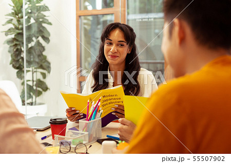 Kind longhaired girl looking at her classmates Kind longhaired girl looking at her classmates 55507902