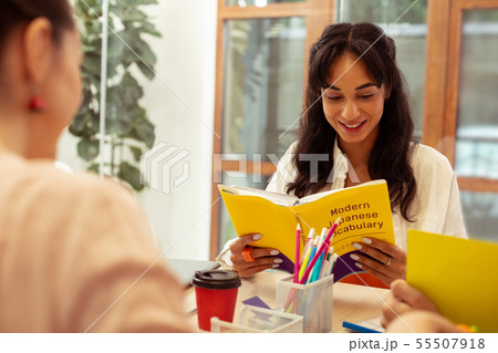 Delighted brunette student learning Japanese with pleasure 55507918