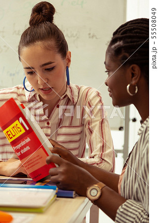 Kind brunette girl staring at her notes Kind brunette girl staring at her notes 55508049