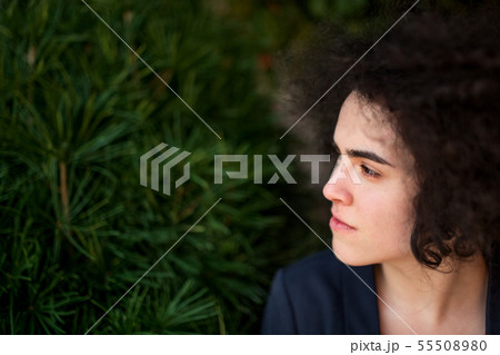 A young businesswoman standing outdoors, relaxing. Copy space. A young businesswoman standing outdoors, relaxing. Copy space. 55508980