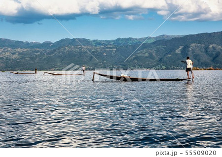Fisherman rowing boat by leg on Inle Lake, Fisherman rowing boat by leg on Inle Lake, 55509020