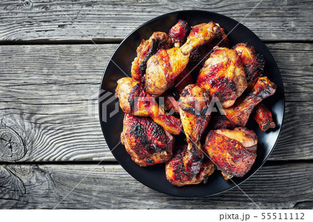 spicy Jerk Chicken on a black plate 55511112