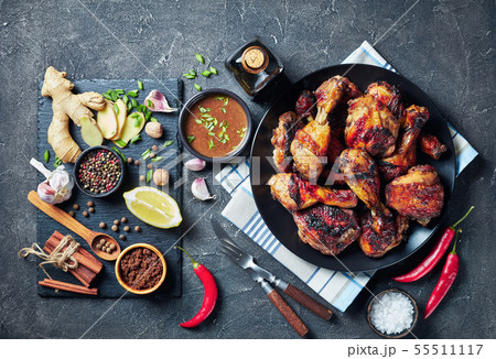 Grilled spicy Jerk Chicken drumsticks and thighs 55511117