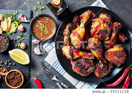 Grilled spicy Jerk Chicken drumsticks and thighs 55511118