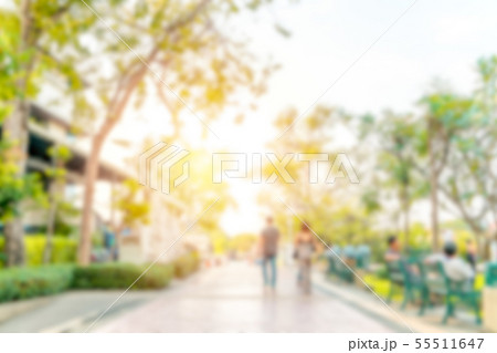 Blurred image of people relaxing at a park Blurred image of people relaxing at a park 55511647