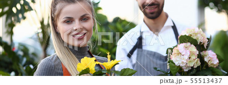 Two Florist Holding Domestic Flower Pot Portrait Two Florist Holding Domestic Flower Pot Portrait 55513437