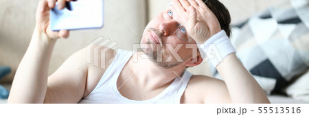 Thoughtful Man Shooting Training on Mobile Phone 55513516