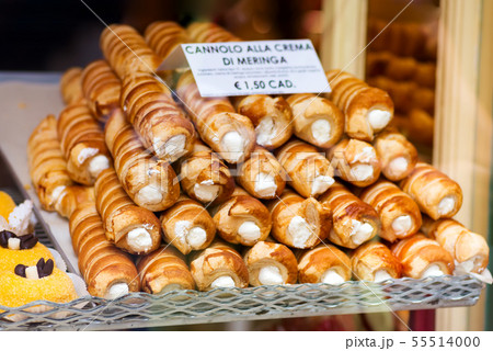 Closeup of cannoli stuffed with cream cheese whipped filling dessert on tray window display in Closeup of cannoli stuffed with cream cheese whipped filling dessert on tray window display in 55514000