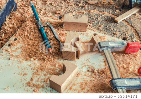 The master makes a hole in the wooden blank 55514171