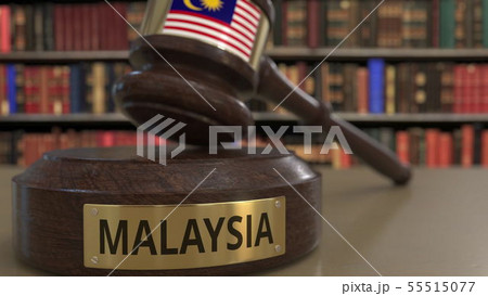 Flag of Malaysia on falling judges gavel in court. National justice or jurisdiction related 55515077