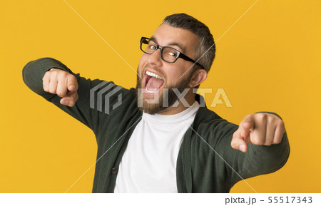Cheerful bearded man happily indicating at camera 55517343