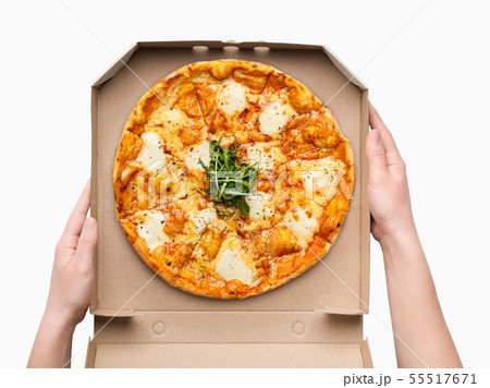 Woman holding delivery box with cheesy pizza 55517671