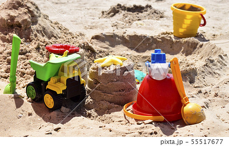 Children's beach toys on sand on a sunny day. 55517677