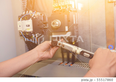 The electrician is connecting the electric cable The electrician is connecting the electric cable 55517860