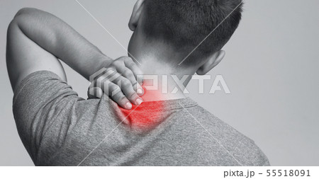 Young man suffering from neck ache, monochrome panorama photo Young man suffering from neck ache, monochrome panorama photo 55518091